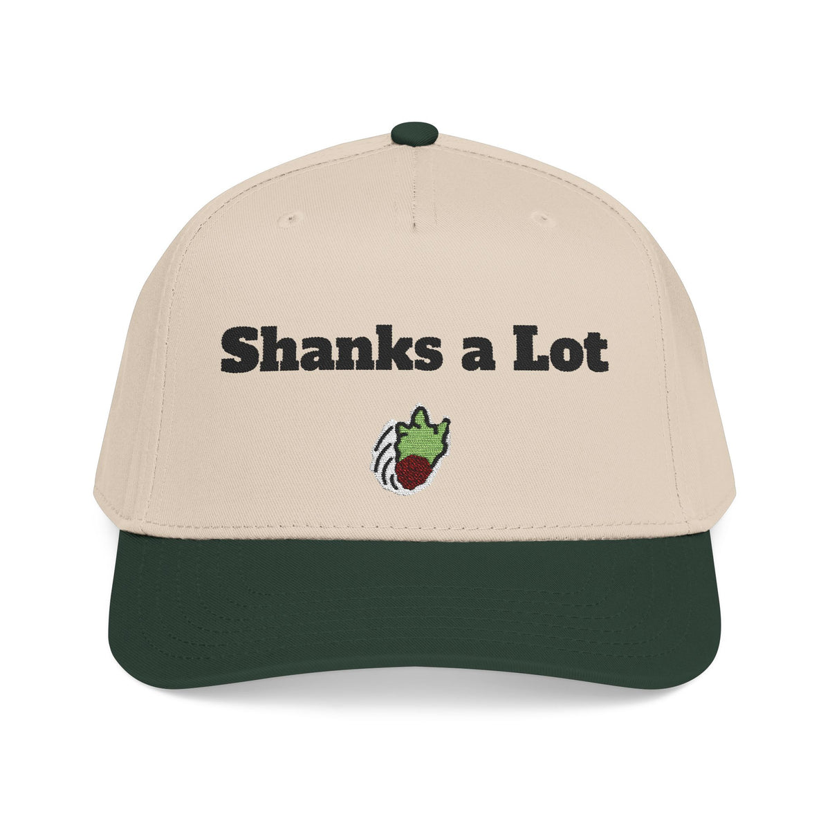 A structured baseball cap with a light beige crown and a dark forest green curved brim. The front of the cap features the text 'Shanks a Lot' in black, with a small embroidered green and red cartoon character below it.